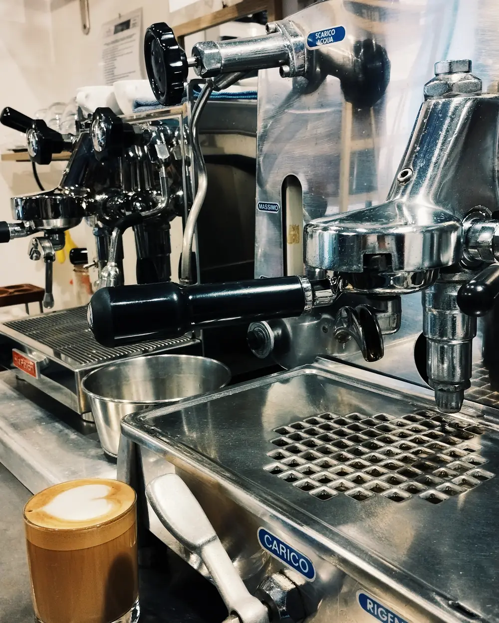 Restored 1960s Faema E61 lever machine at Artefact, a cappuccino sitting on the drip tray