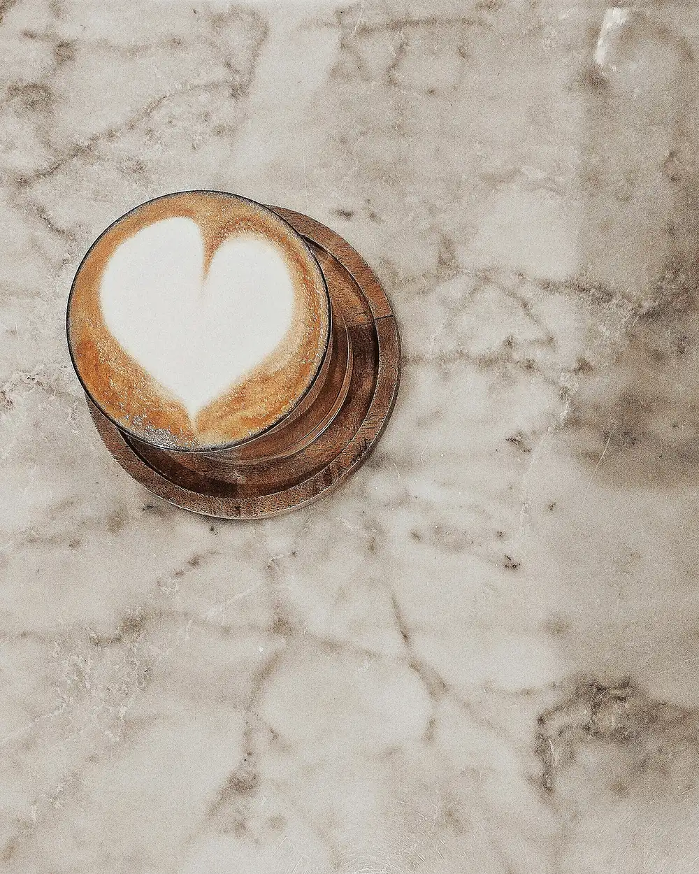 Cappuccino with latte art on a marble table at Artefact Frascati